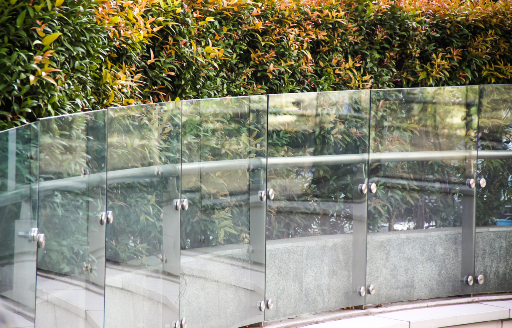 Fascia mount glass balustrade with handrail along a Brisbane walkway