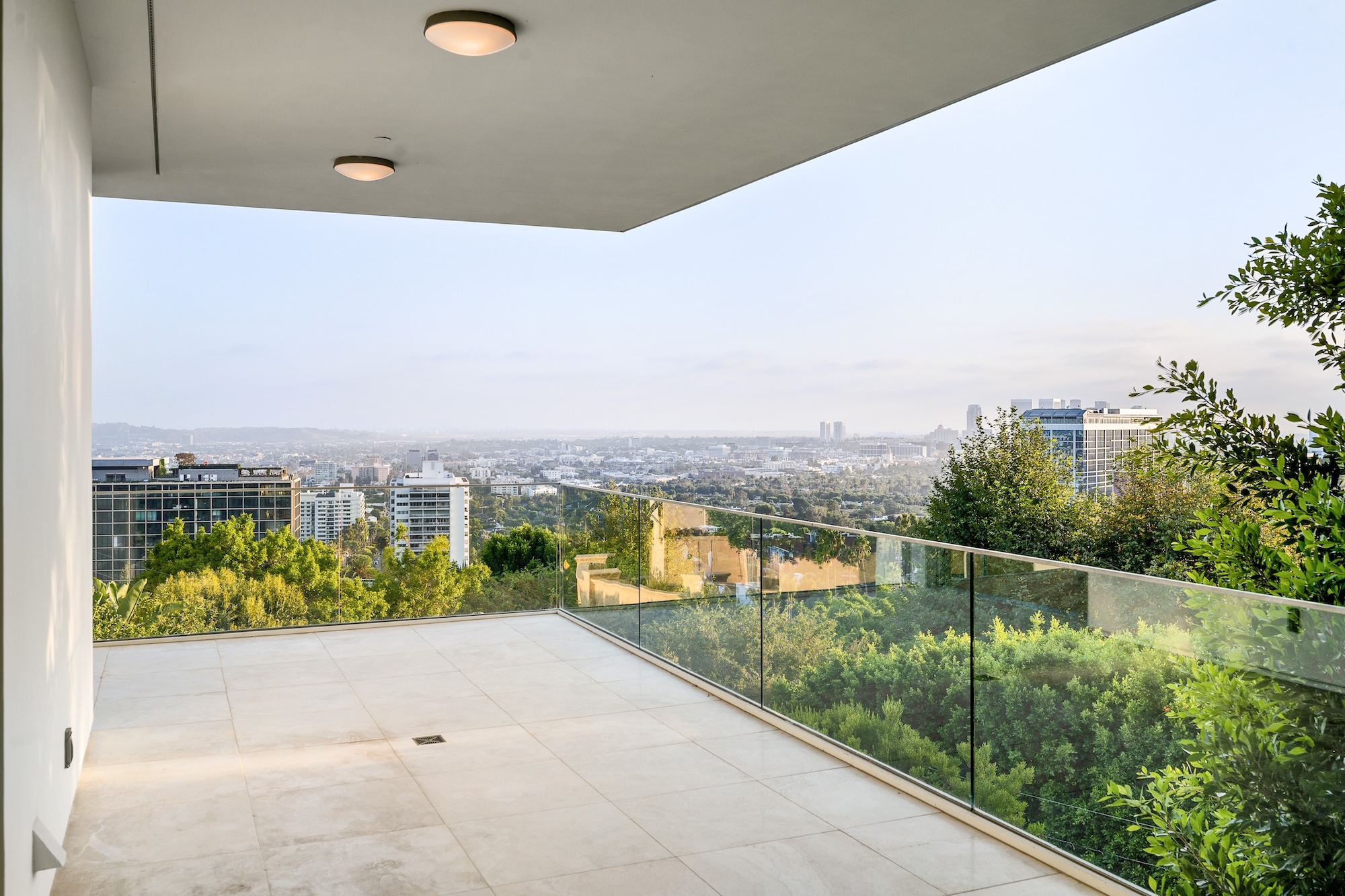 Frameless glass balustrade on a modern balcony overlooking Brisbane